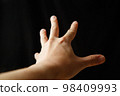 outstretched hand on black background 98409993