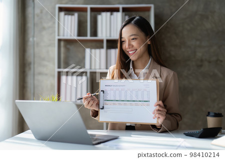 Asian Business woman working at home office and analyze financial report document. Accounting and Finance concept 98410214