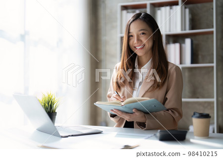 Asian Business woman working at home office and analyze financial report document. Accounting and Finance concept 98410215