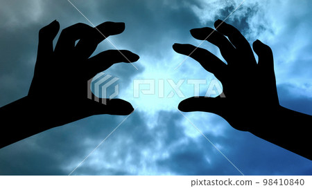 Scary two-handed silhouette _ suspicious sky background _ wide 98410840
