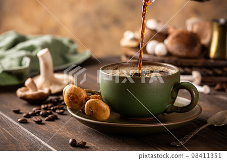 Mushroom coffee in green cup Mushroom coffee in green cup 98411351