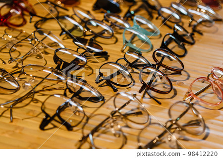 large selection of sunglasses and glasses on a stand 98412220