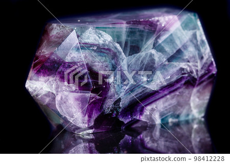 Macro mineral stone Fluorite crystal on a black background Macro mineral stone Fluorite crystal on a black background 98412228