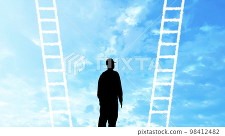 Silhouette of a person standing in front of two ladders_blue sky background wide 98412482