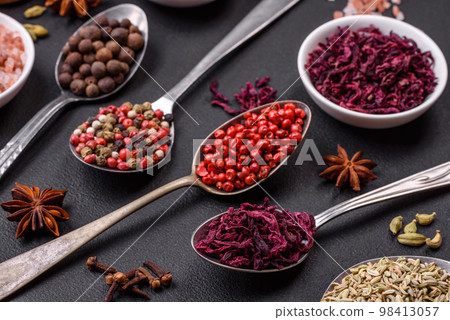 Composition consisting of variations of spices in white bowls and metal spoons 98413057