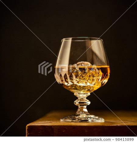 Glass of scotch whiskey and ice 98413899
