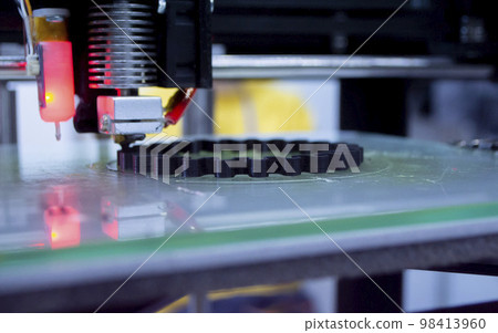 3d printer printing a model close-up. The process of printing a model on a 3D printer made of orange plastic. 3D printer working close up 3d printer printing a model close-up. The process of printing a model on a 3D printer made of orange plastic. 3D printer working close up 98413960