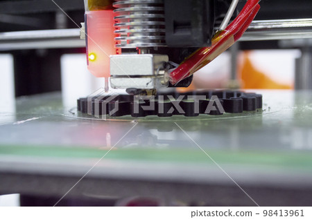 3d printer printing a model close-up. The process of printing a model on a 3D printer made of orange plastic. 3D printer working close up 3d printer printing a model close-up. The process of printing a model on a 3D printer made of orange plastic. 3D printer working close up 98413961