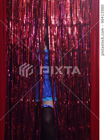 Woman Preforming Burlesque on Stage. Blue Corset Costume With Red Background Woman Preforming Burlesque on Stage. Blue Corset Costume With Red Background 98413980