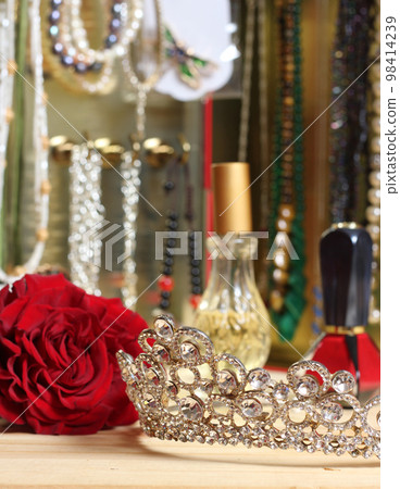 Rose and Tiara with Perfume and Jewelry in Background 98414239