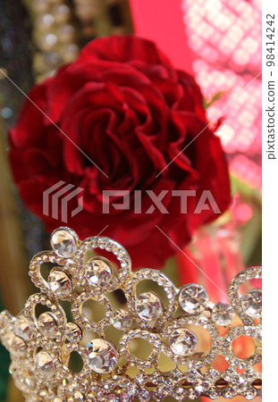 Rose and Tiara with Perfume and Jewelry in Background 98414242