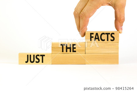 Just the facts symbol. Concept words Just the facts on wooden blocks on a beautiful white table white background. Businessman hand. Business and just the facts concept. Copy space. 98415264