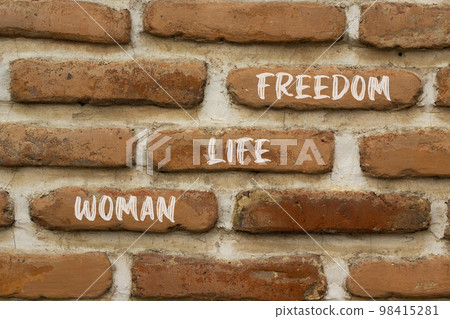 Woman life freedom symbol. Concept words Woman Life Freedom on red brown brick wall on a beautiful brick wall background. Social issue woman life freedom concept. Copy space. Woman life freedom symbol. Concept words Woman Life Freedom on red brown brick wall on a beautiful brick wall background. Social issue woman life freedom concept. Copy space. 98415281