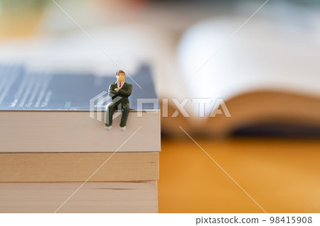 English books opened on the desk Image of research learning re-learning Male figure in suit 98415908
