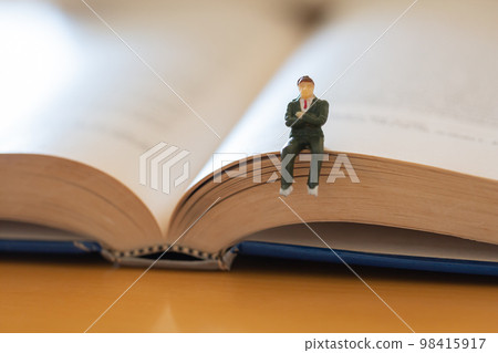 English books opened on the desk Image of research learning re-learning Male figure in suit English books opened on the desk Image of research learning re-learning Male figure in suit 98415917