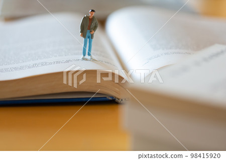 English book opened on the desk Image of research, learning, re-learning Male figure 98415920