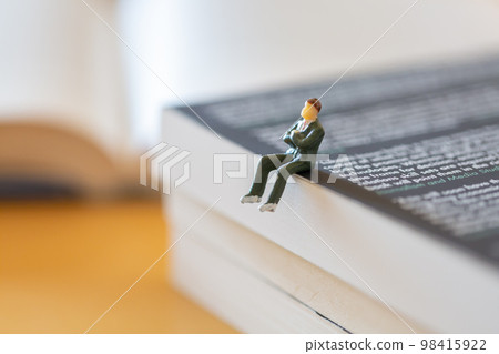 English books opened on the desk Image of research learning re-learning Male figure in suit 98415922