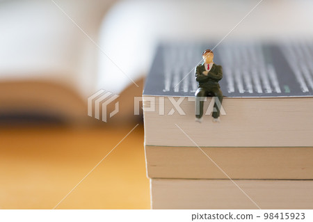 English books opened on the desk Image of research learning re-learning Male figure in suit English books opened on the desk Image of research learning re-learning Male figure in suit 98415923
