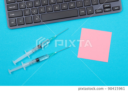 Vaccination or Revaccination Concept - Two Medical Syringe on Blue Table Vaccination or Revaccination Concept - Two Medical Syringe on Blue Table 98415961