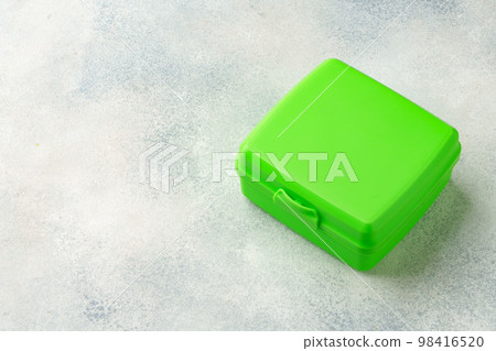 New plastic lunch box on a gray background New plastic lunch box on a gray background 98416520