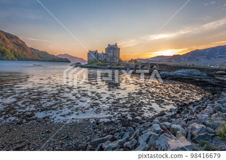 Colorful sunset against Eilean Donan Castle at Kyle of Lochalsh in the Western Highlands of Scotland Colorful sunset against Eilean Donan Castle at Kyle of Lochalsh in the Western Highlands of Scotland 98416679