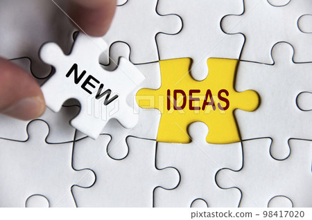 New ideas text on missing jigsaw puzzle. Business idea concept New ideas text on missing jigsaw puzzle. Business idea concept 98417020