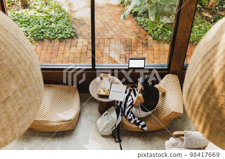 Top view of woman using cellphone in cafe. Top view of woman using cellphone in cafe. 98417669