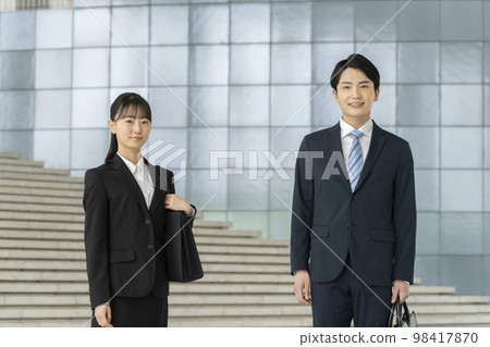 Young men and women wearing suits with a smile looking at the camera, job hunting students, Freshers image 98417870