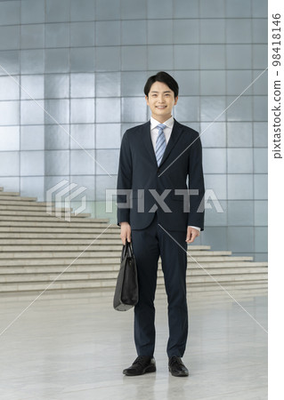 穿著西裝的年輕人看著相機全身肖像 穿著西裝的年輕人看著相機全身肖像 98418146
