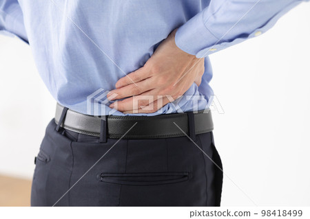 Businessman low back pain Businessman low back pain 98418499