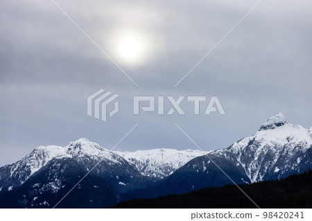 Snow and Cloud covered Canadian Nature Landscape Background. Winter Season in Whistler 98420241
