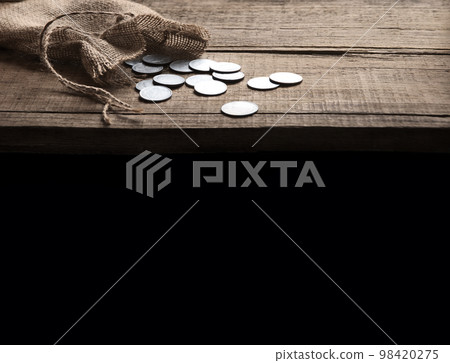 Thirty coins in a bag on the table 98420275