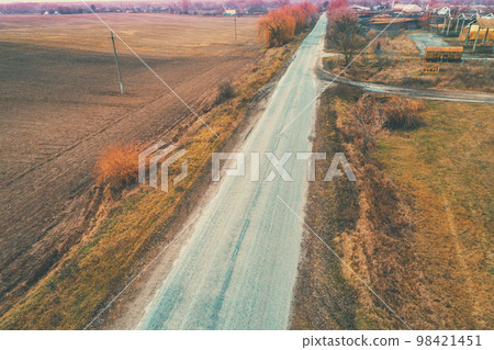 Aerial view of countryside and straight country road. Farmland in autumn Aerial view of countryside and straight country road. Farmland in autumn 98421451