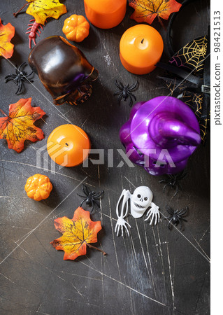 Creative background Halloween party concept. Holiday decorations - Halloween pumpkins, candle, lantern and decoration on dark stone background. View from above. Copy space. 98421513