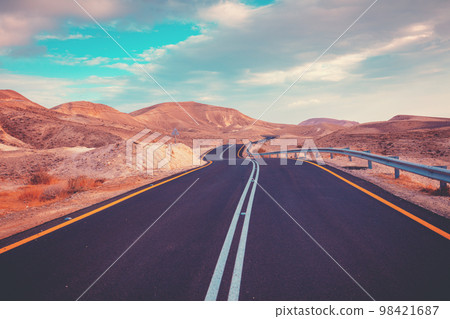 Driving a car on a mountain road. Desert landscape Driving a car on a mountain road. Desert landscape 98421687