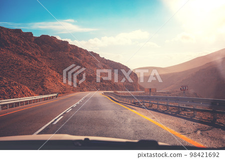 Driving a car on a mountain road. Desert landscape. The road from Arad to the Dead Sea 98421692