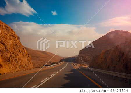 Driving a car on a mountain road. Desert landscape. The road from Arad to the Dead Sea 98421704