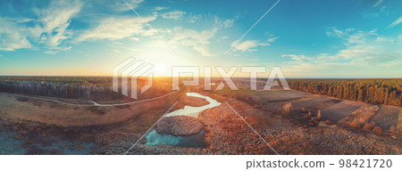 Aerial view of the countryside. Frozen brook in the evening at sunset light 98421720