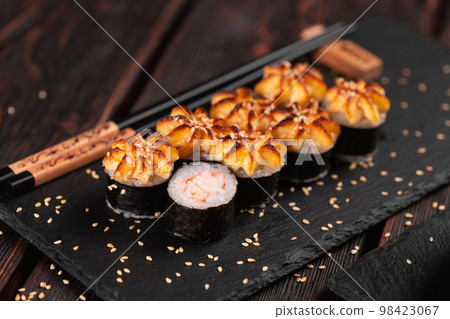 Japanese hot maki roll sushi with shrimp close-up - asian food concept Japanese hot maki roll sushi with shrimp close-up - asian food concept 98423067