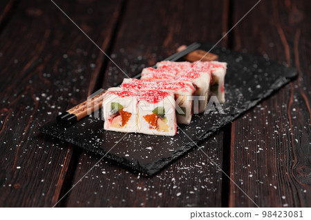Asian sweet dessert maki sushi - Roll with fruits and cream cheese with coconut flakes and topping 98423081