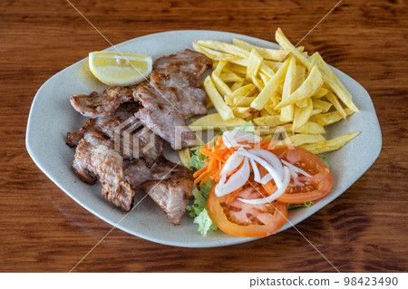 A traditional Portuguese dish of roasted black pig meat and fried potatoes. Secretos A traditional Portuguese dish of roasted black pig meat and fried potatoes. Secretos 98423490