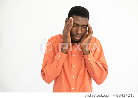Portrait of stressed young man touching head Portrait of stressed young man touching head 98424215