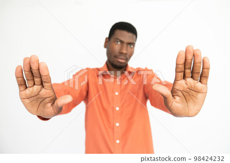 Close-up of male hands making stop gesture over white background 98424232