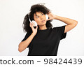 Portrait of concentrated young woman listening to music 98424439