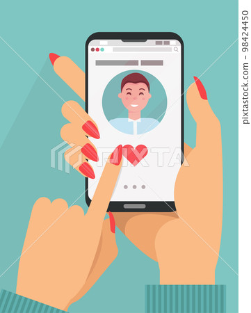 Online dating app concept. female hands in suit holding smartphone with cute dark hair man on screen.Online dating, long distance relationship concept. Finger presses heart button. Flat cartoon vector 98424450