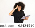 Portrait of happy young woman using digital tablet 98424510