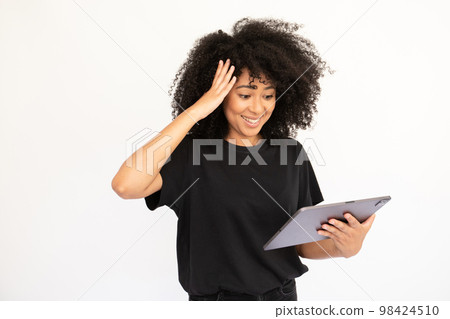Portrait of happy young woman using digital tablet Portrait of happy young woman using digital tablet 98424510