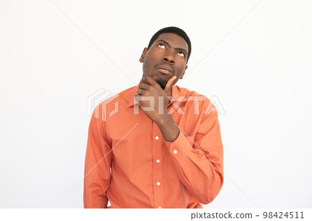 Portrait of thoughtful young man touching chin Portrait of thoughtful young man touching chin 98424511