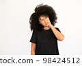 Portrait of stressed young woman touching aching neck 98424512