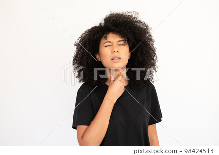 Portrait of unwell young woman suffering from angina Portrait of unwell young woman suffering from angina 98424513